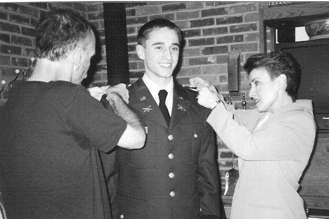 Scott & Catherine Mater pin new second lieutenant bars on their son, Josh Mater, at his commissioning ceremony in December 2002.